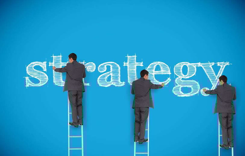 Multiple image of businessman writing strategy on a giant blue wall