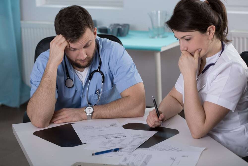 Worried doctors who did mistake in medical records-1