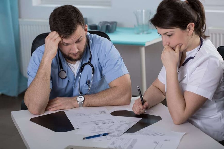 Worried doctors who did mistake in medical records-2
