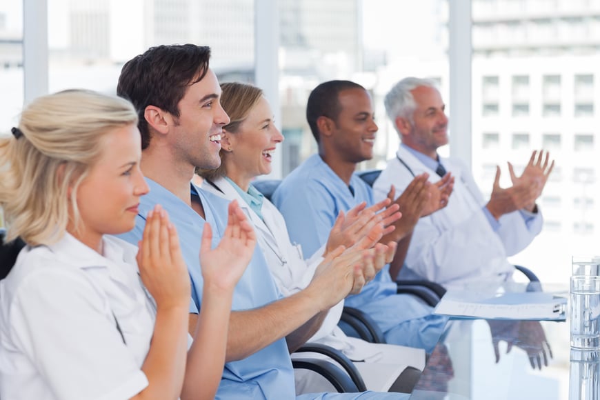Doctors clapping their hands during a conference