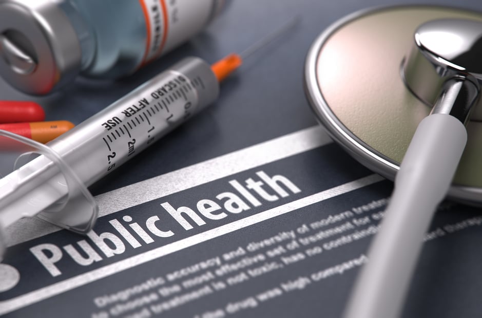 Public Health. Medical Concept with Blurred Text, Stethoscope, Pills and Syringe on Grey Background. Selective Focus.-1
